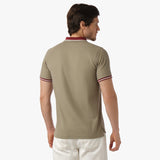 Back view of a man wearing the olive polo shirt: The man is standing with his back to the camera, showing the back fit and design of the shirt, with maroon accents on the collar and cuffs.