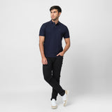 The navy blue polo shirt laid flat, displaying the front design and button details.