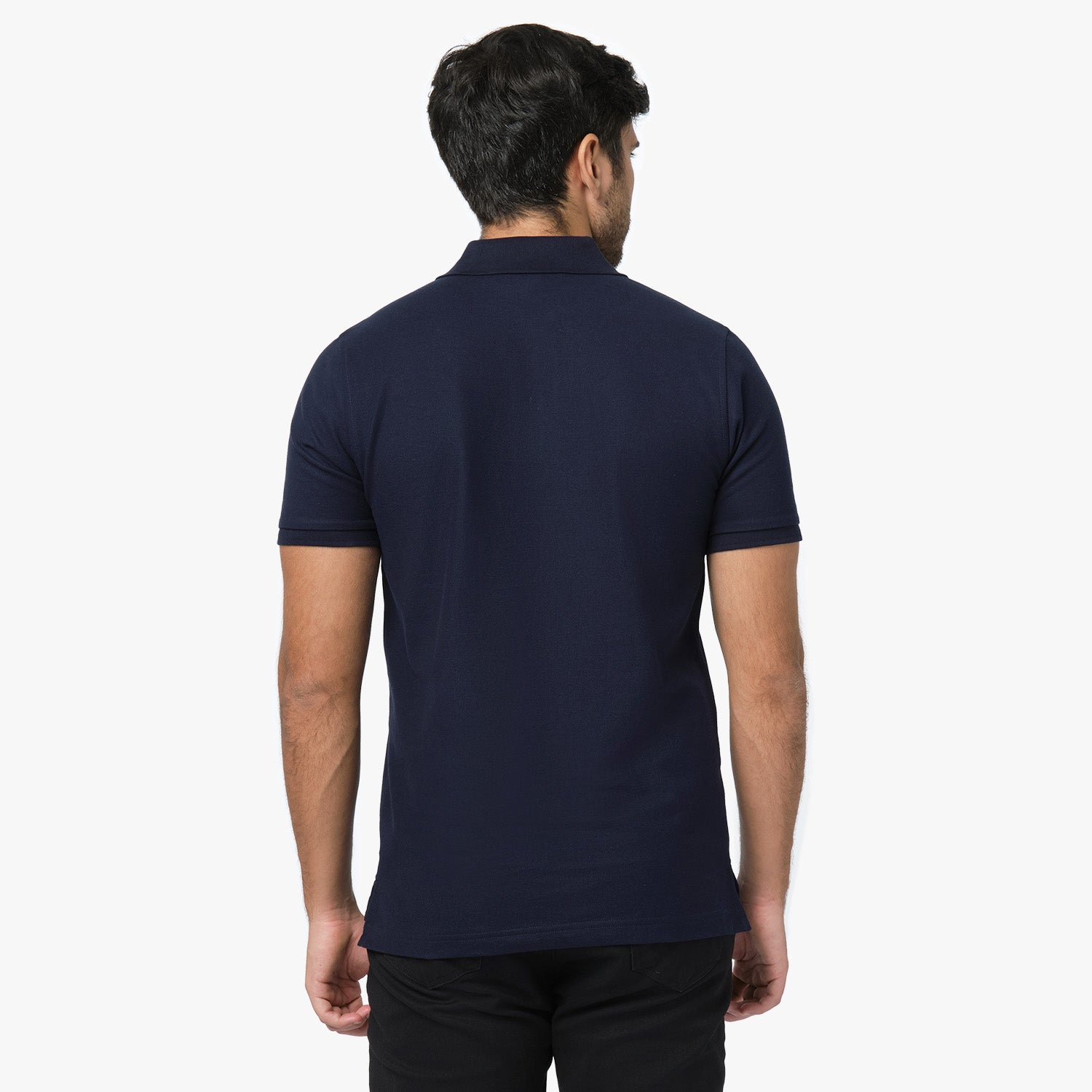 Rear view of a man wearing the navy blue polo shirt, showing the fit from behind.