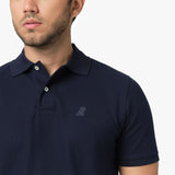 Close-up of the collar and embroidered logo on the navy blue polo shirt, focusing on the branding.