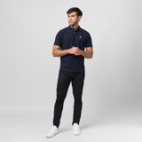 A navy blue polo shirt laid flat, showing the collar and small embroidered logo on the chest.