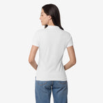 Rear view of the woman wearing the white polo shirt, showing the back design.