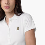 Close-up of the woman’s face and chest, highlighting the collar and black logo on the white polo shirt.