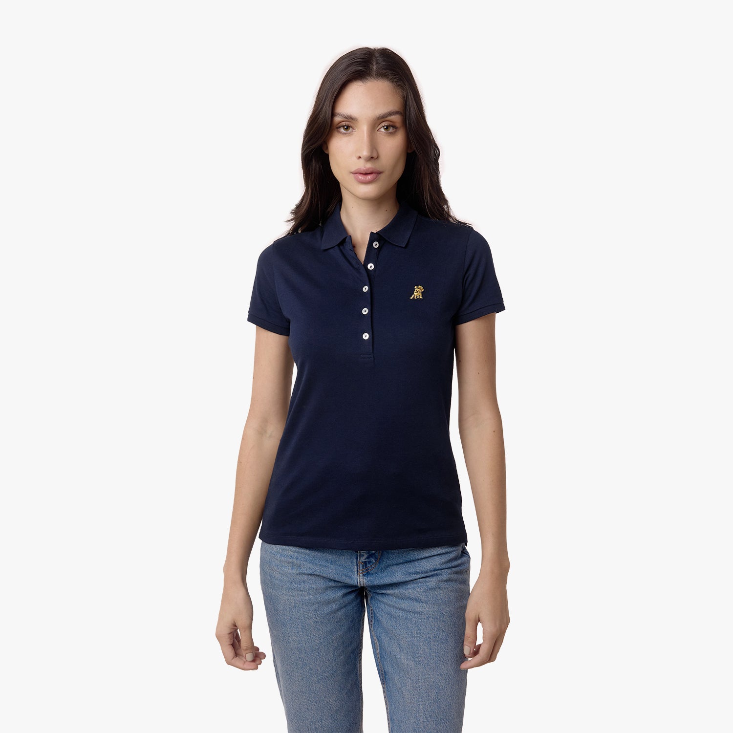 Woman wearing a navy blue polo shirt with a gold logo, standing with her hands by her sides.