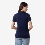 Rear view of the woman wearing the navy blue polo shirt, showing the back design.