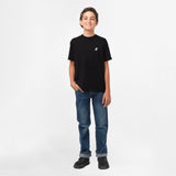 Boy standing while wearing the black t-shirt and jeans, facing forward.