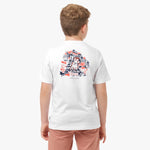 Rear view of a boy wearing a white T-shirt with a colorful graphic on the back, showing a detailed illustration in red, navy blue, and black.