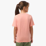 Rear view of a girl wearing the light pink t-shirt, standing with her hands behind her back.