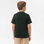 Rear view of a boy wearing the black t-shirt, standing with his hands behind his back.