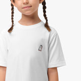 Close-up front view of a girl wearing the white t-shirt with a small embroidered logo on the chest.