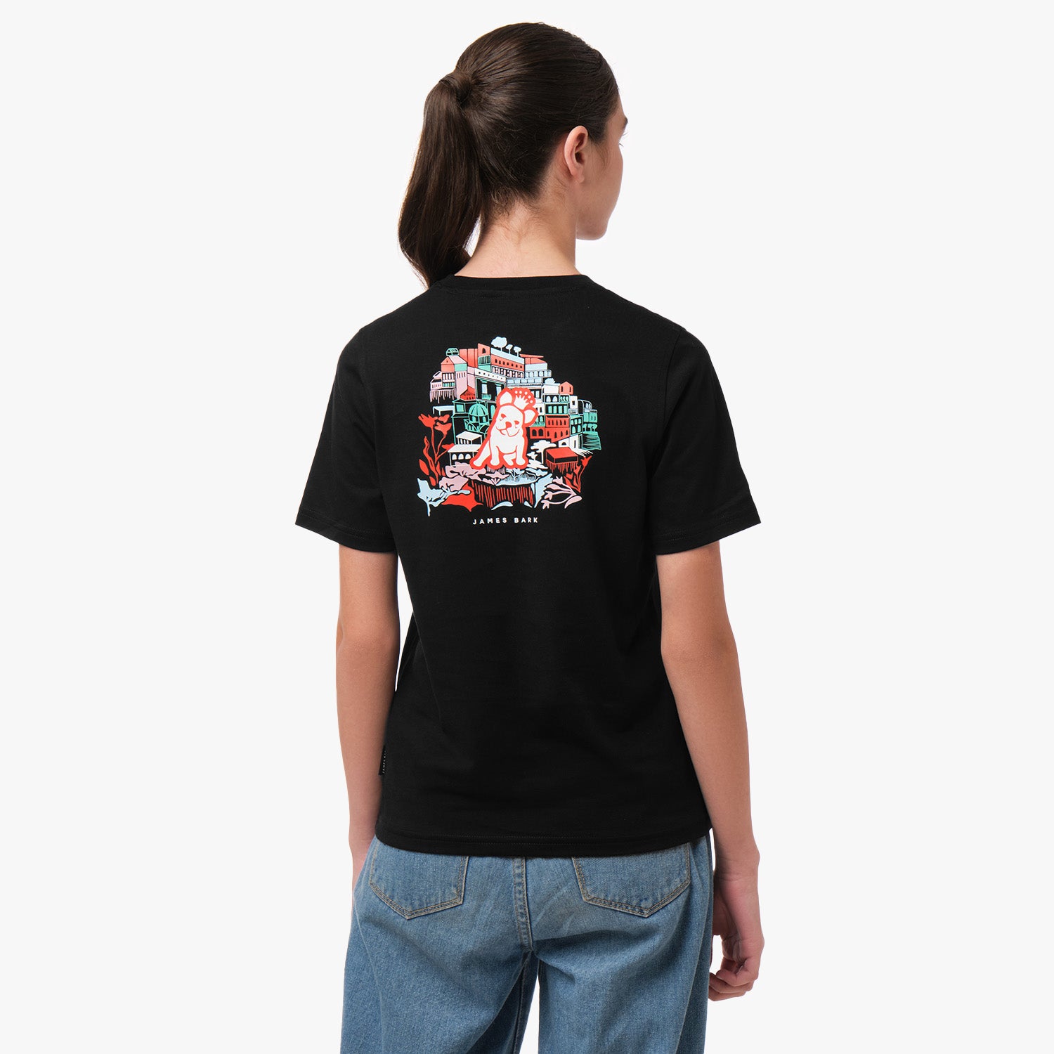 Rear view of a girl wearing a black T-shirt with a colorful graphic on the back, featuring an intricate design in red, green, and white.