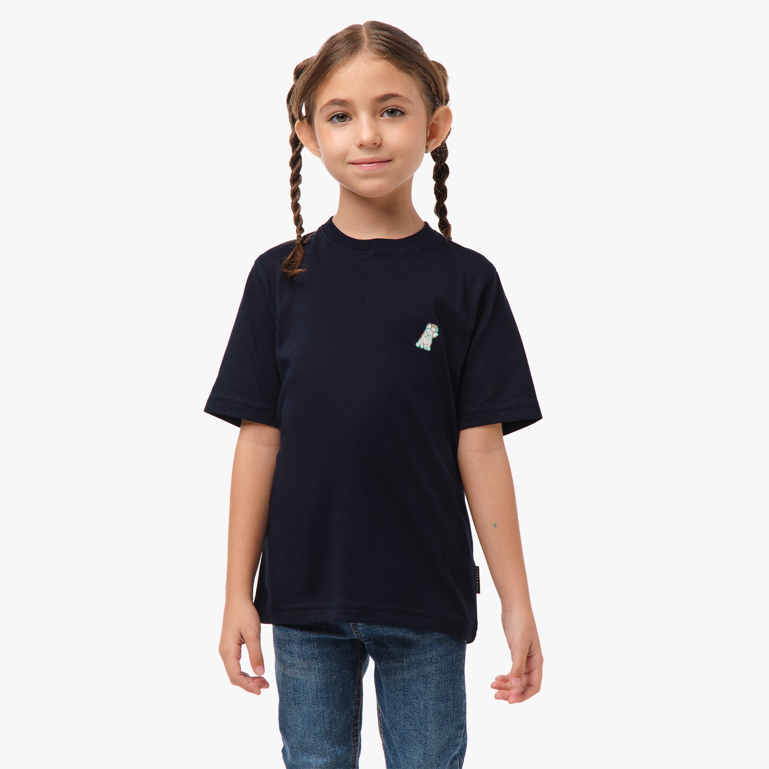 Front view of the girl wearing the black T-shirt with a small embroidered logo on the chest, paired with jeans.