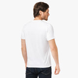 Back view of a man wearing the white t-shirt: The man is standing with his back to the camera, showing the simple back design of the t-shirt.