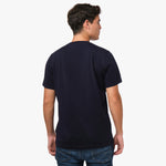 Back view of a man wearing the navy blue t-shirt: The man is standing with his back to the camera, showing the simple back design of the t-shirt.