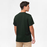 Back view of the man wearing the dark green t-shirt, standing with his arms at his sides, paired with beige shorts.