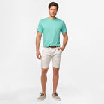 A full-body image of the man wearing the mint green t-shirt and white shorts, standing in a relaxed posture.