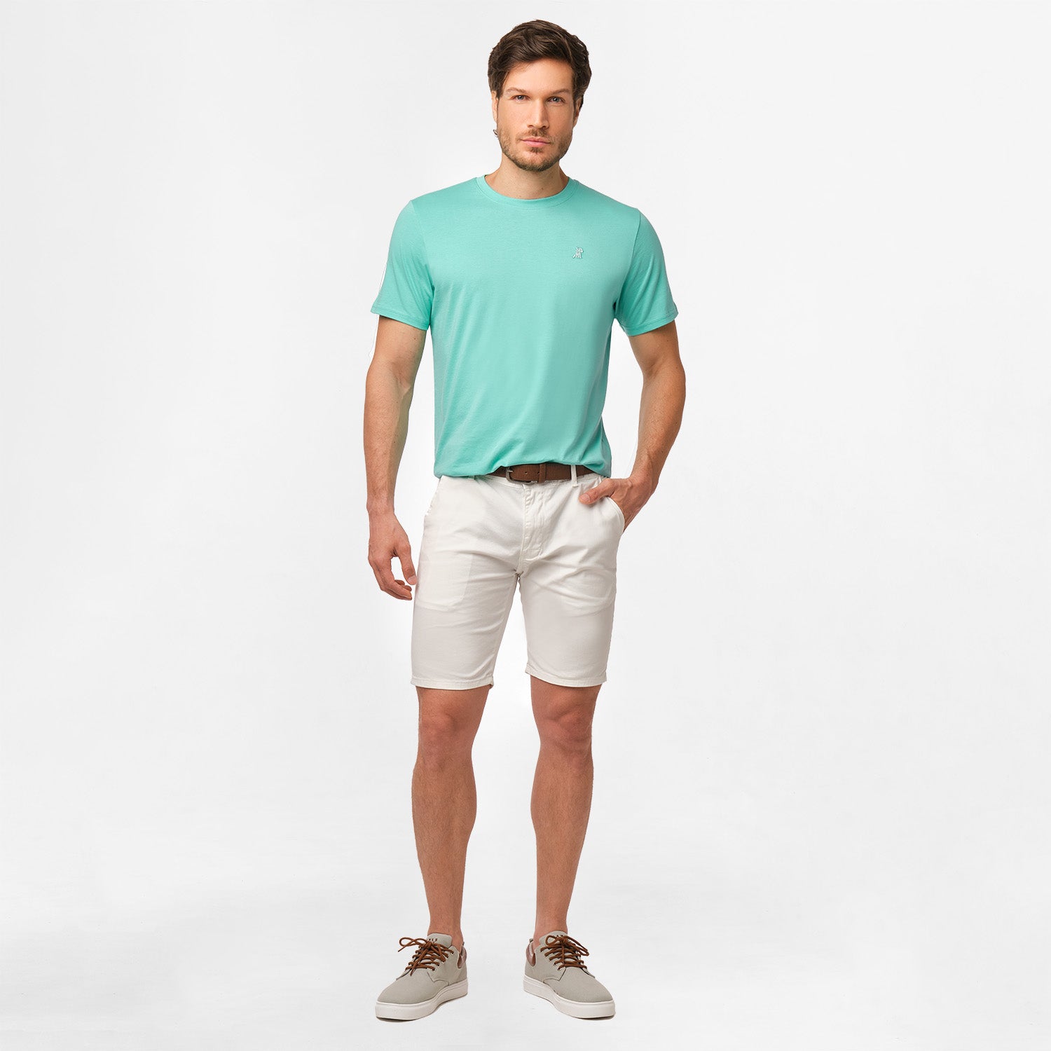 A full-body image of the man wearing the mint green t-shirt and white shorts, standing in a relaxed posture.