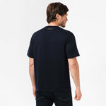 Rear view of the model wearing the navy blue t-shirt, showcasing the fit from behind.