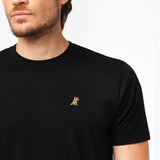 Side view close-up of the collar and chest of the black t-shirt: A detailed side profile showing the crew neck collar and the small embroidered dog logo on the left chest.