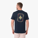 A man viewed from the back wearing a navy blue T-shirt with a large playing card graphic on the back