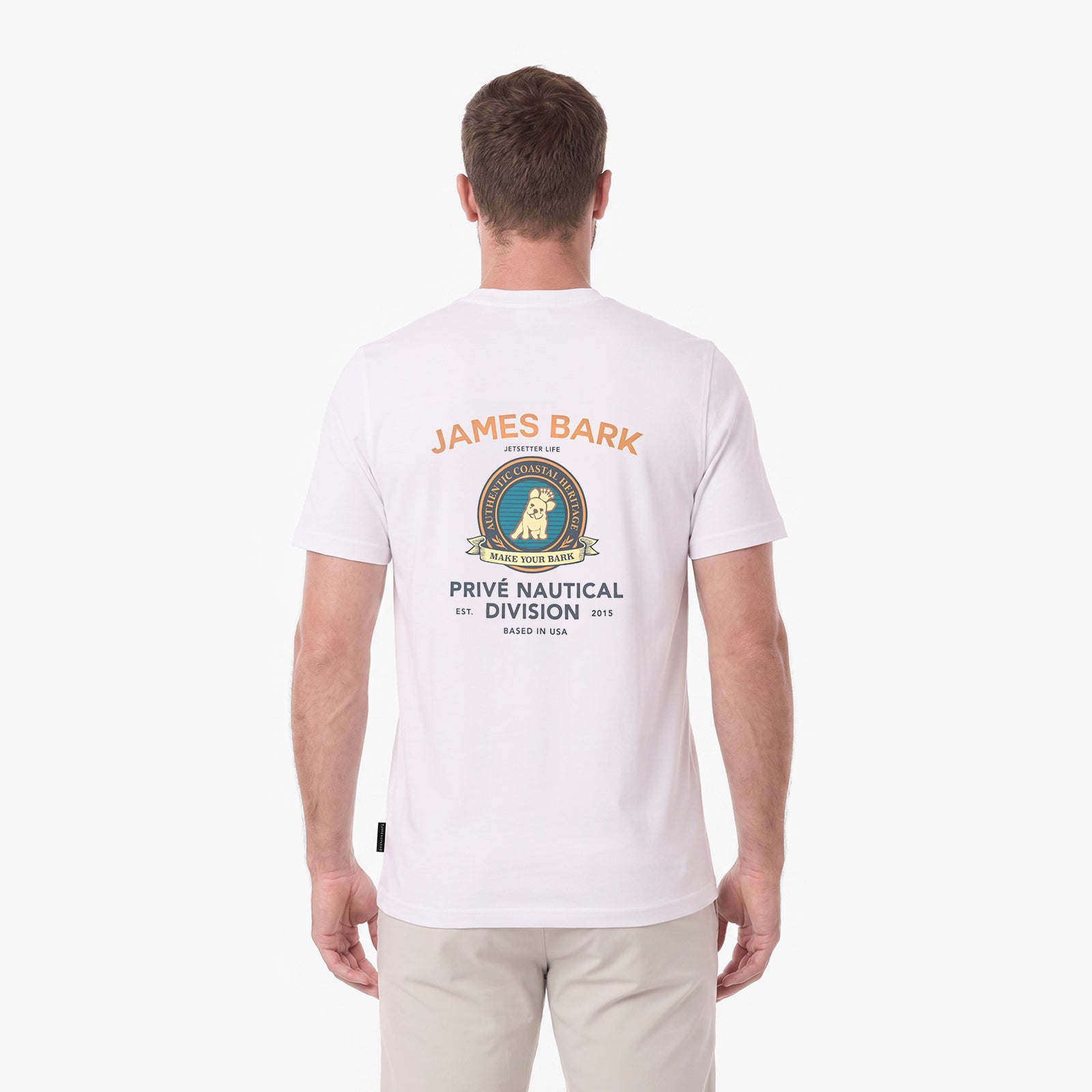 A man viewed from the back wearing a white T-shirt with a large James Bark Prive Nautical Division graphic printed on the back