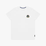 A white T-shirt with a small circular crest printed on the left chest. The inner collar features a contrasting navy blue trim, and a small black tag is visible near the bottom-right hem.