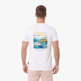 A man viewed from behind wearing a white T-shirt with a large graphic print on the back. The graphic features the text 'JAMES BARK' in yellow and blue, above an illustration of a yacht on blue water with mountains and a lighthouse.