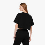 Back view of a woman wearing a black James Bark Elements cropped t-shirt and matching joggers.