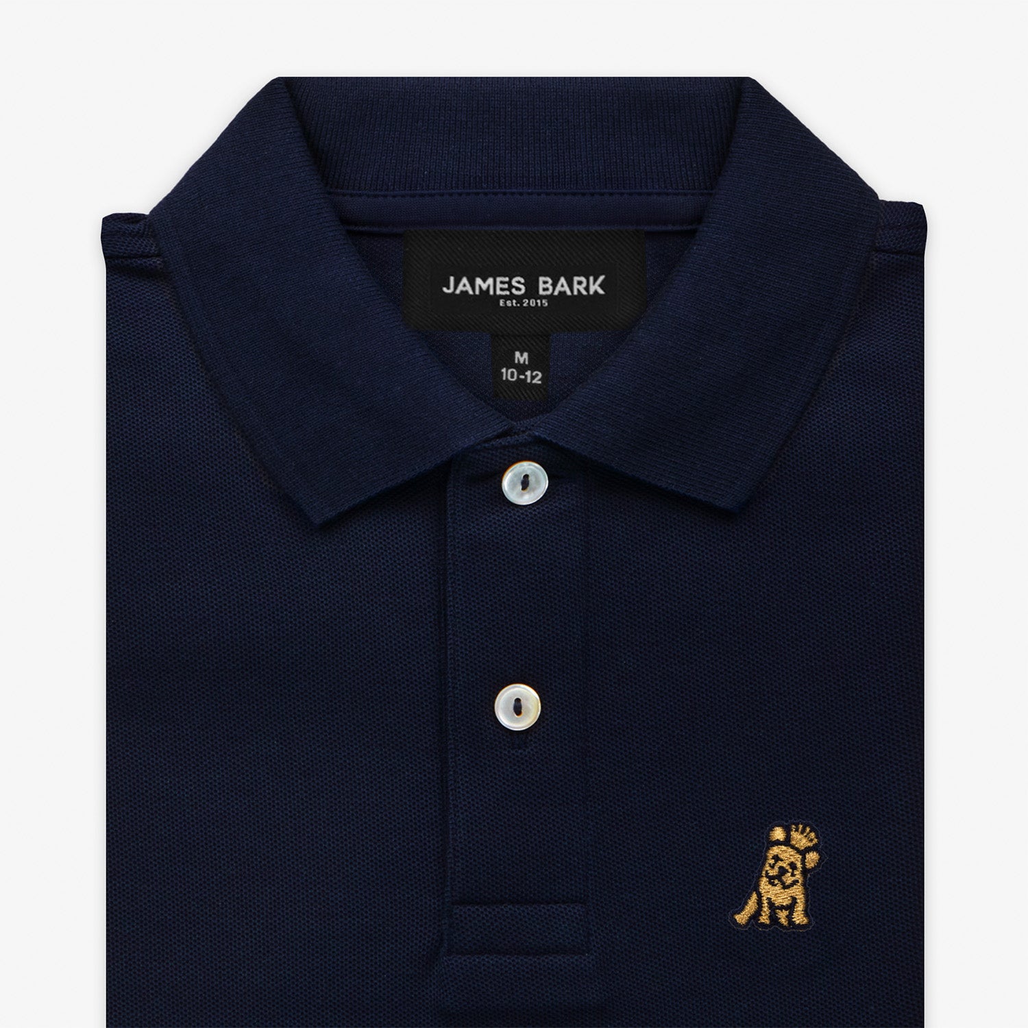 Close-up of the collar and chest area of the navy blue polo shirt, showing the button placket and the gold embroidered logo.