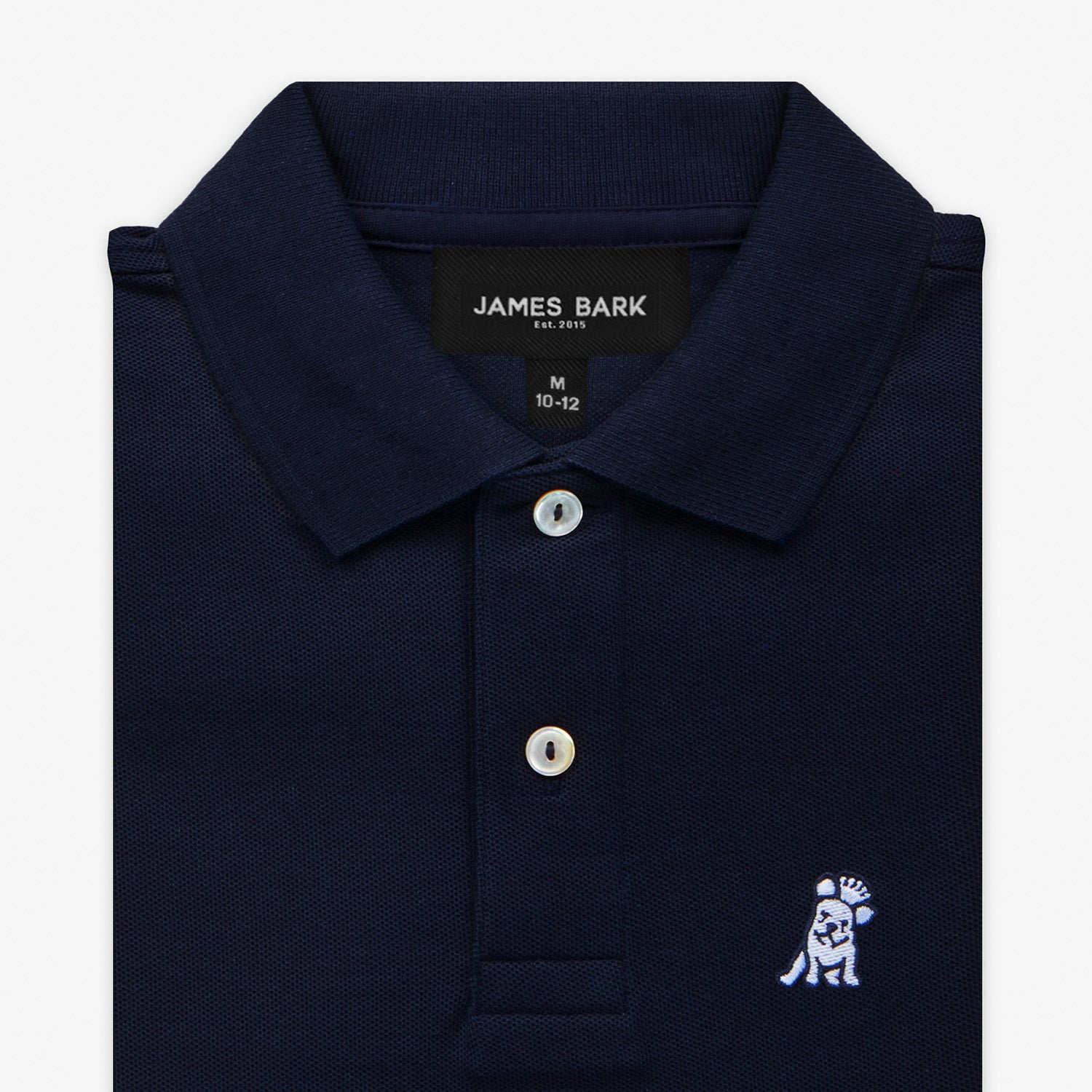 Close-up of the collar and chest area of the navy blue polo shirt, showing the button placket and embroidered logo.