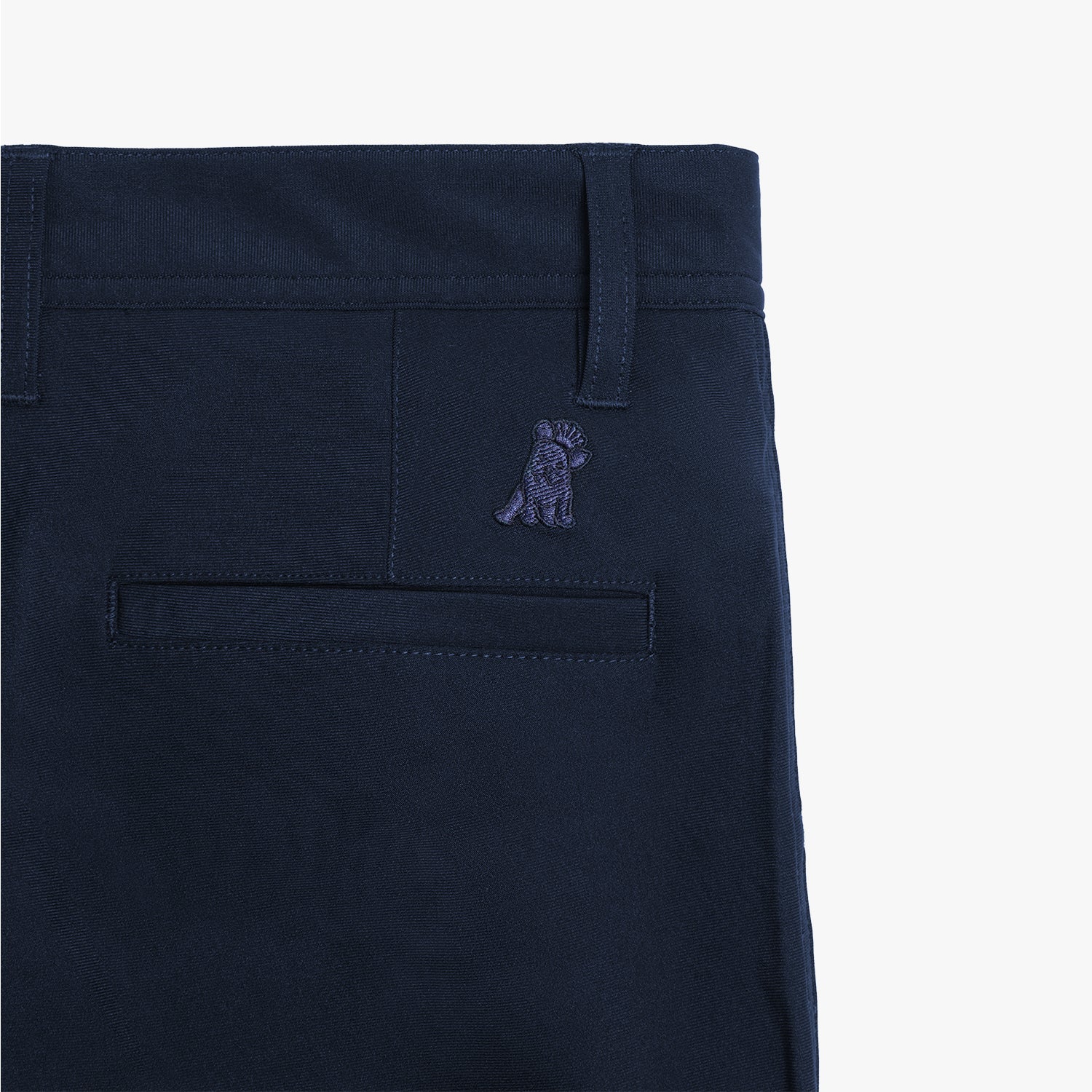 A detailed close-up of the pocket stitching and subtle embroidered logo on the navy blue pants.