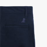 A detailed close-up of the pocket stitching and subtle embroidered logo on the navy blue pants.