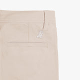 Another close-up of the back pocket on the beige pants, showing the pocket detail and logo embroidery.