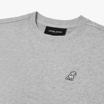 Close-up of the neckline and embroidered dog logo on the gray sweatshirt, emphasizing the fabric texture and details