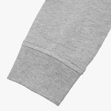 Close-up of the cuff detail on the gray sweatshirt, showcasing the stitching and fabric texture