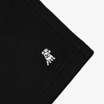 Close-up of the embroidered dog logo on the black shorts, highlighting the detailed stitching