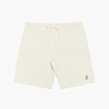 Flat-lay front view of cream-colored shorts featuring a drawstring waistband and a small embroidered dog logo near the hem