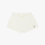 Beige shorts laid flat with an elastic waistband, drawstring, and a small embroidered logo on the lower left side