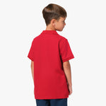 Rear view of the boy wearing the red polo shirt, showing the plain back design.