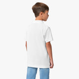 Rear view of the boy wearing the white polo shirt, showing the plain back design.