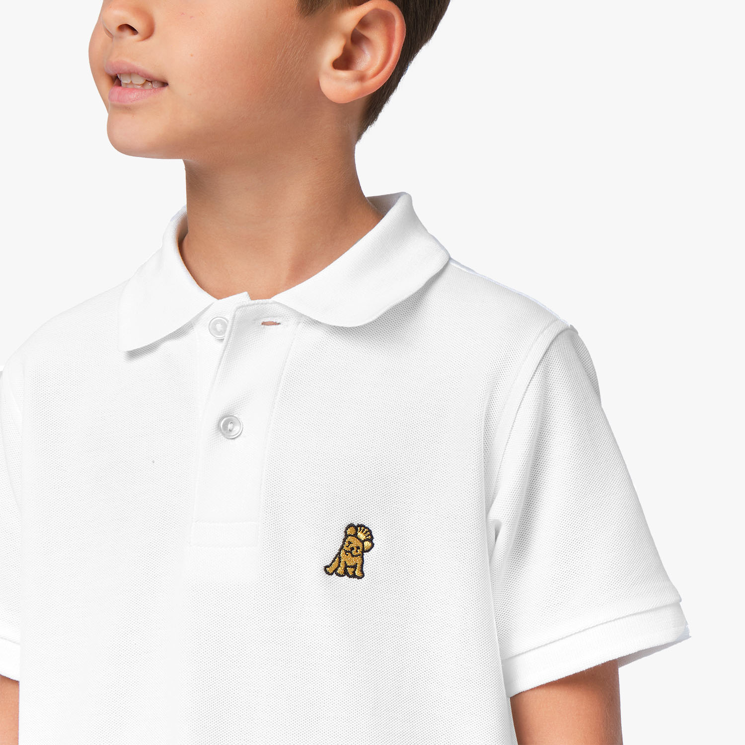 Close-up of the chest area of the white polo shirt, featuring the small embroidered logo.