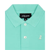 Close-up of the collar and chest area of the mint green polo shirt, showing the button placket and embroidered logo.