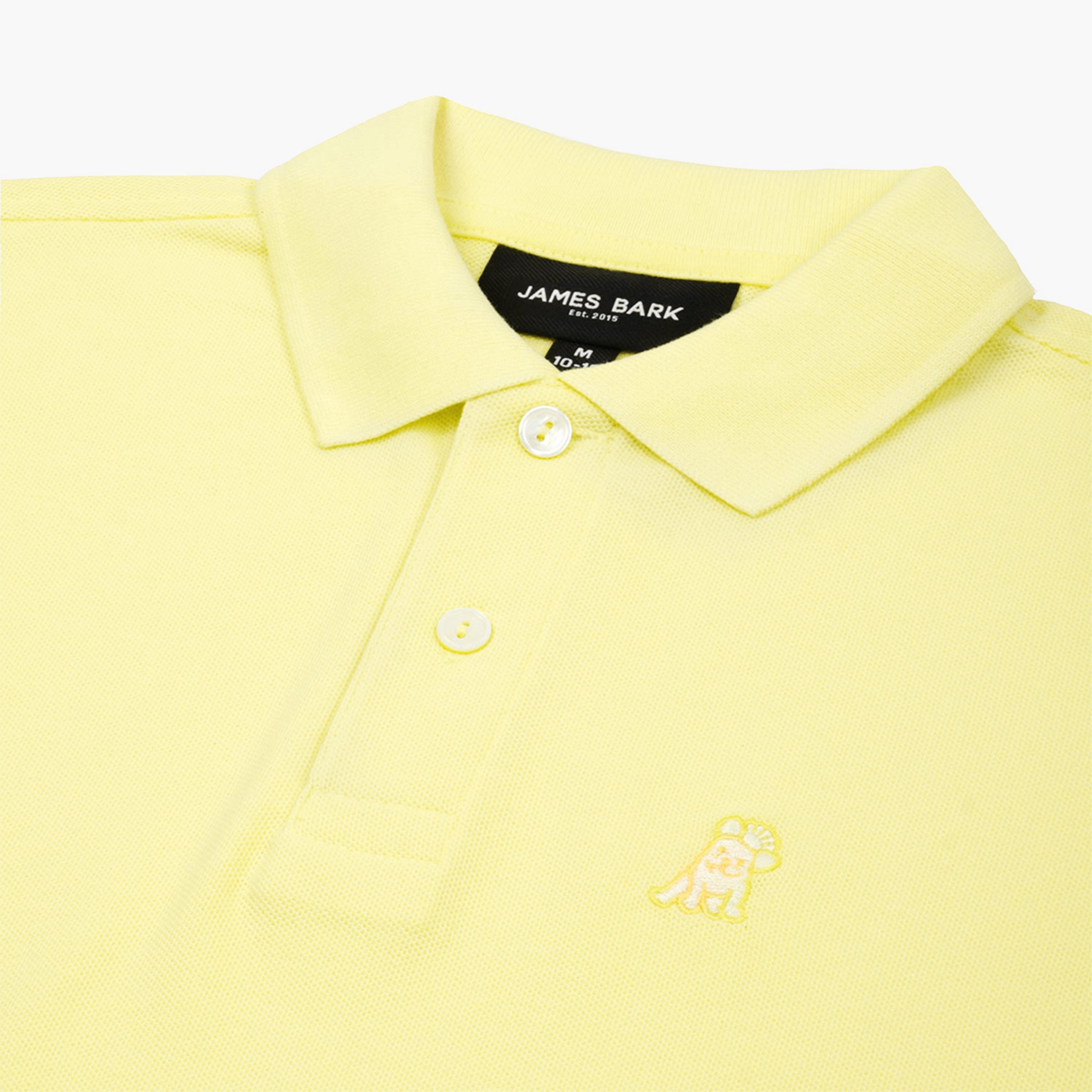 Close-up of the neckline and collar of the yellow polo shirt, showing the button details.