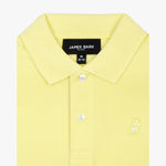 Close-up of the collar and chest area of the yellow polo shirt, showing the button placket and embroidered logo.