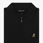 Close-up view of the black polo shirt collar and zipper, featuring the gold embroidered logo on the left chest.