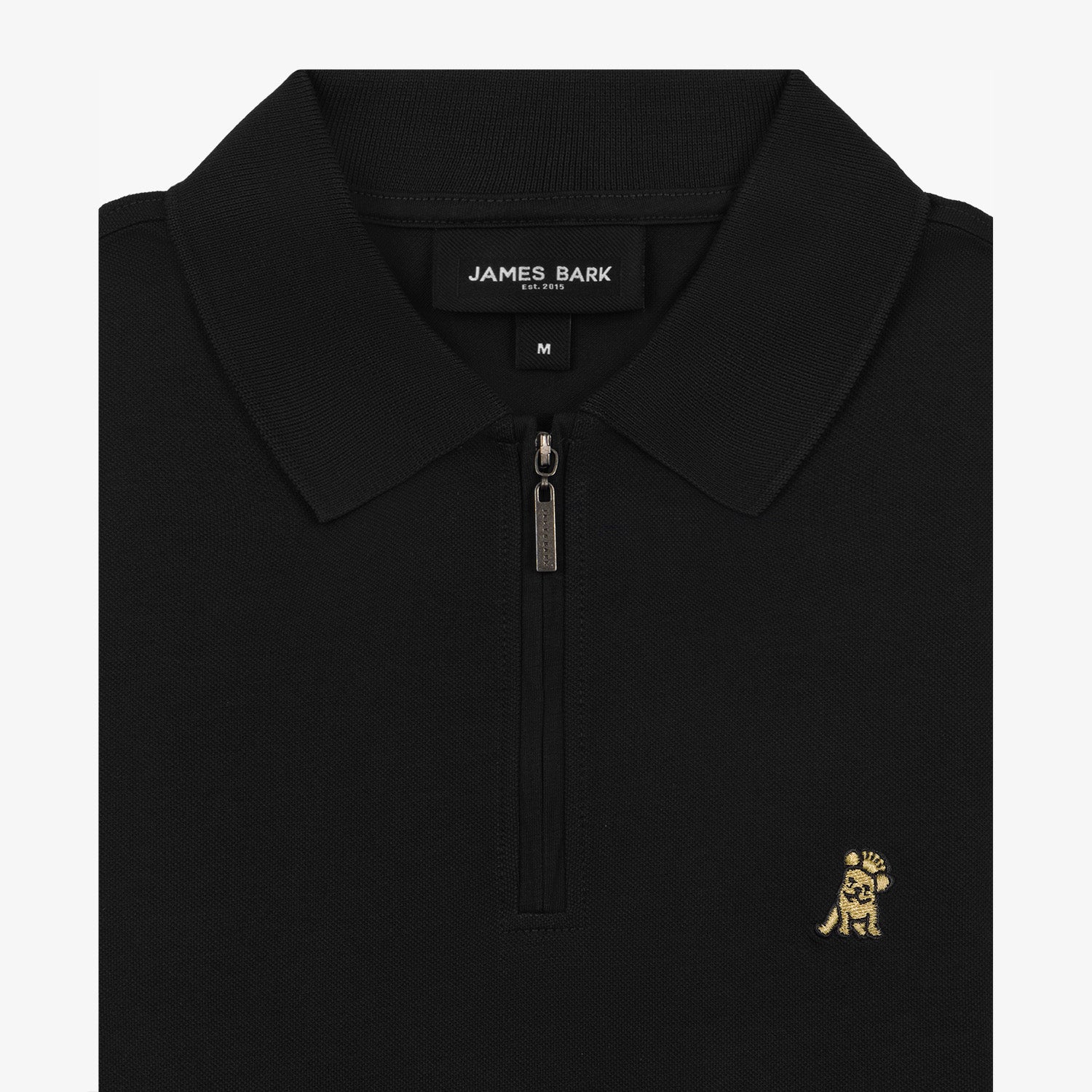 Close-up view of the black polo shirt collar and zipper, featuring the gold embroidered logo on the left chest.