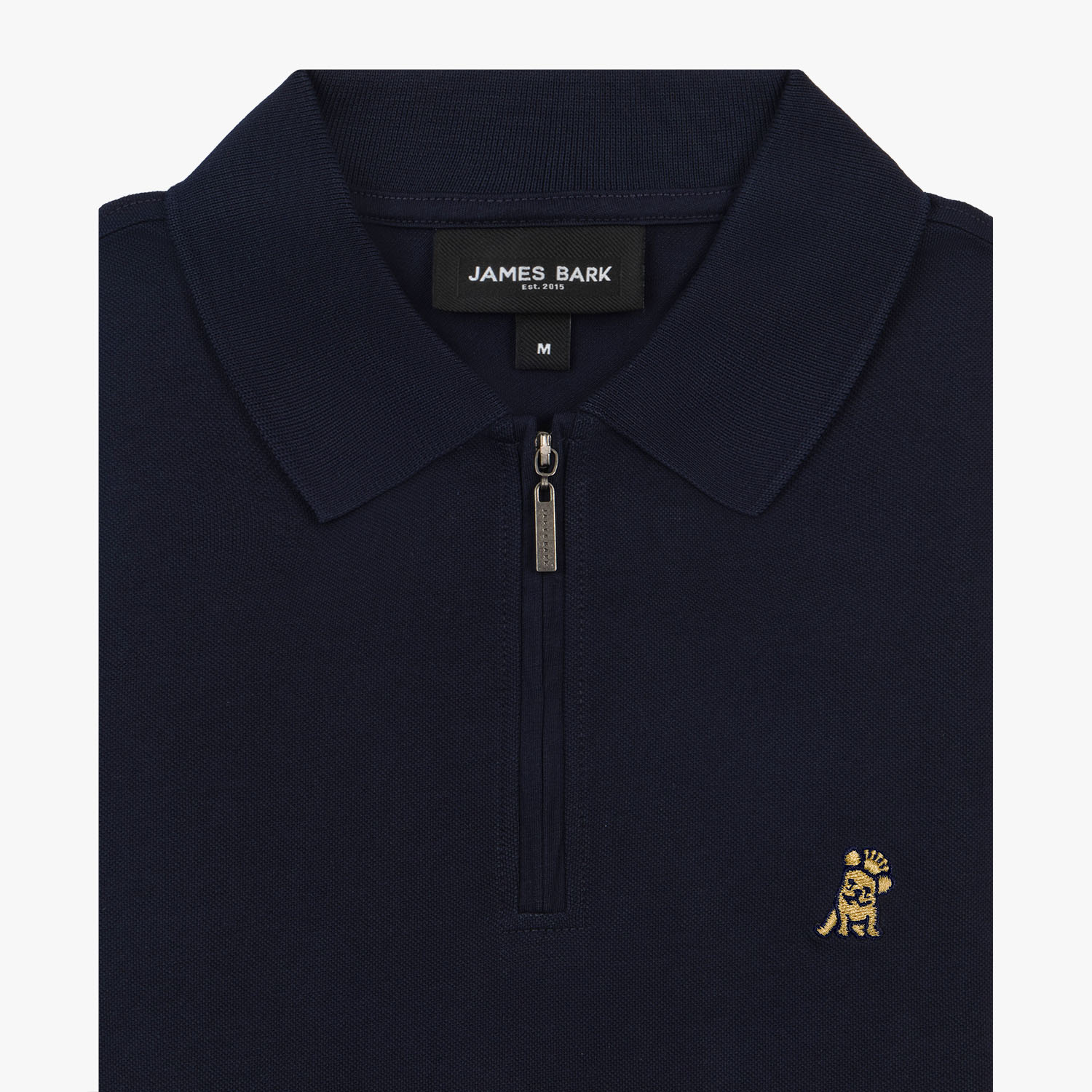 Close-up of the navy blue polo shirt collar and zipper, showcasing the embroidered gold logo.