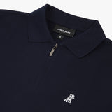 Flat lay of the navy blue polo shirt, showing the logo on the left chest and the zipper design