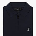 Close-up of the collar of a navy blue polo shirt featuring a zipper and a logo beneath the collar.