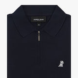 Close-up of the collar of a navy blue polo shirt featuring a zipper and a logo beneath the collar.